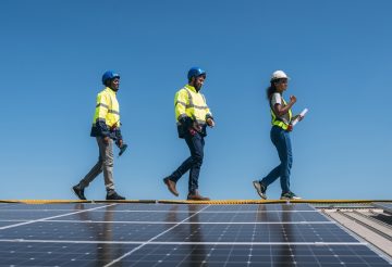 Service engineer checking solar cell on the roof for maintenance if there is a damaged part. Engineer worker install solar panel. Clean energy concept.